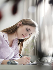 woman writing something n paper